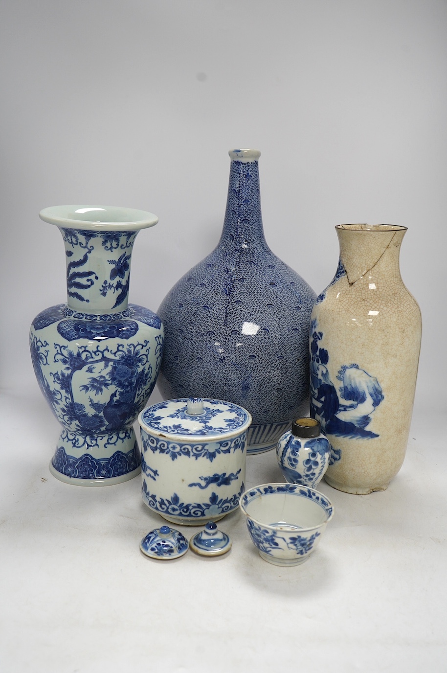 Four Chinese blue and white vases, a jar and cover and a tea bowl, Kangxi to 20th century, tallest vase 38cm high. Condition - poor